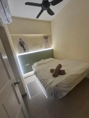 a bed with a stuffed animal on it in a room at Sri Sayang Home Stay in George Town