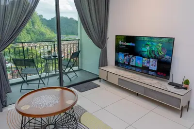 a living room with a flat screen tv and a balcony at Ipoh Tambun Lost World Sunway Onsen Suite 2R 8Pax Mira Theme Park View in Ipoh