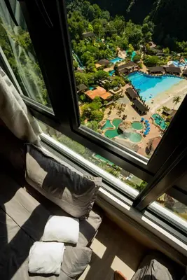 a room with a window with a view of a resort at Ipoh Tambun Lost World Sunway Onsen Suite 2R 8Pax Mira Theme Park View in Ipoh