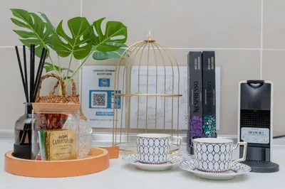 a kitchen counter with two cups and a bird cage at Ipoh Tambun Lost World Sunway Onsen Suite 2R 8Pax Mira Theme Park View in Ipoh