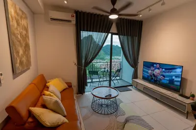 a living room with a couch and a flat screen tv at Ipoh Tambun Lost World Sunway Onsen Suite 2R 8Pax Mira Theme Park View in Ipoh
