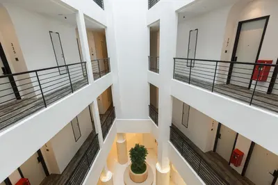 a view of a hallway of a building with a potted plant at Wellesley Hotel in Simpang Ampat