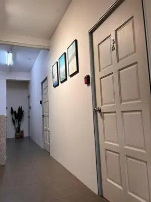 a door in a hallway with pictures on the wall at Room1#IG theme Bargainous#Shared Bathroom#3pax#2min Kek Lok Si in Ayer Itam