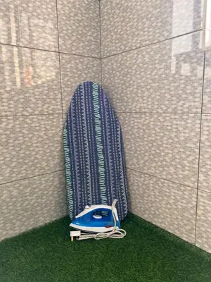 a blue phone sitting on the grass next to a wall at Room1#IG theme Bargainous#Shared Bathroom#3pax#2min Kek Lok Si in Ayer Itam