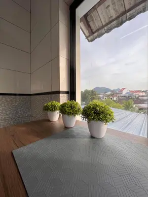 three potted plants in a room with a large window at Room3#IG theme Bargainous#Shared Bathroom#2pax#2min Kek Lok Si in Ayer Itam