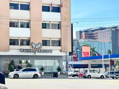 a white car parked in front of a building at Dim Sum Homestay in Ipoh