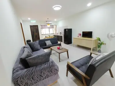 a living room with a couch and a table at Dim Sum Homestay in Ipoh