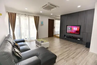 a living room with a couch and a flat screen tv at 75 pangkor ocean in Pangkor