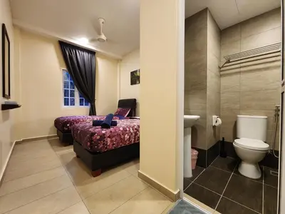 a bathroom with a bed and a toilet and a sink at Fathers Guesthouse Age 7 years old and above only in Tanah Rata