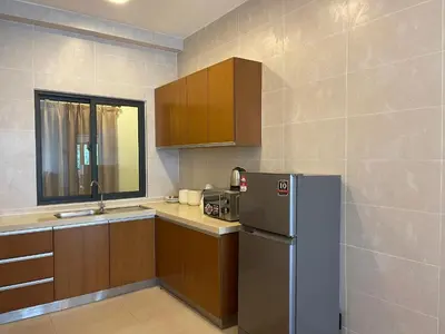 a kitchen with a refrigerator and a sink at NOVA Apartment at Cameron in Cameron Highlands