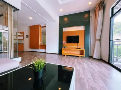 a living room with a tv and a glass table at NOVA Apartment at Cameron in Cameron Highlands