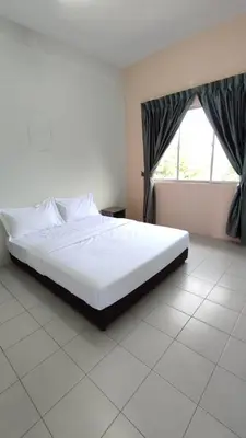 a white bed in a room with a window at Pusing Holiday Apartment in Pusing