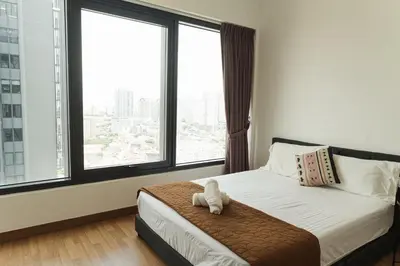 a bedroom with a bed with a teddy bear on it at The CEDAR, 2BR Cityview by WStay @ Tropicana 218 Macalister in George Town
