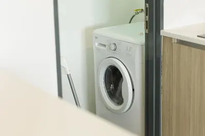 a washing machine in a bathroom next to a sink at The CEDAR, 2BR Cityview by WStay @ Tropicana 218 Macalister in George Town