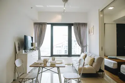 a living room with a couch and a table at The WHITE, 2BR Cityview by WStay @ Tropicana 218 Macalister in George Town