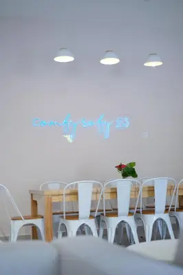 a table and chairs in a white room at Comfy Sofy 23- Balcony Garden (Night market) in Tanah Rata