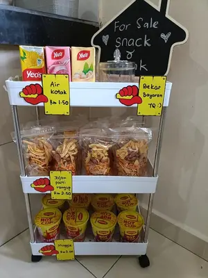 a display of food on a shelf with signs at Homestay Haji Din Tronoh Perak in Teronoh