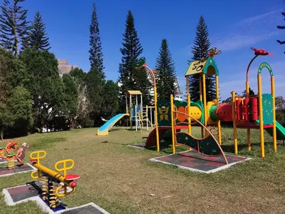 a playground with a bunch of play equipment in a park at Little England B3 in Bukit Fraser