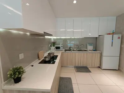 a kitchen with white cabinets and a white refrigerator at The Ipoh All Suite Resort, Jalan Haven Ipoh in Ipoh