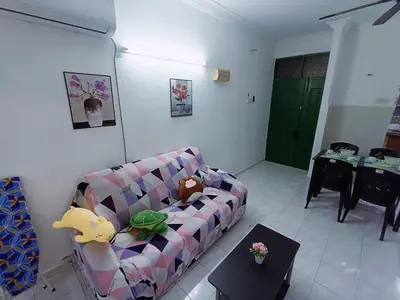 a living room with a couch and a table at Cozy 3 Bedroom Apartment Bandar Perda BM in Bukit Mertajam