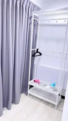 a room with a shelf and a window with curtains at Sunrise@Gurney Spacious 2BR Duplex in George Town