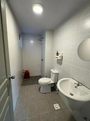 a bathroom with a toilet and a sink at The Misty Penthouse in Tanah Rata