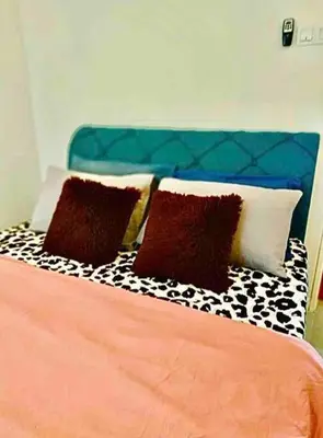 a bed with black and white pillows on it at SUPER COMFY HOME @ KULIM CITY in Kulim