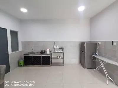 a kitchen with a sink and a refrigerator at HK Homestay in Ipoh