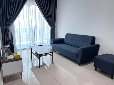 a living room with a blue couch and a table at METROPOL SERVICED APARTMENT at Bukit Mertajam, Pulau Pinang in Bukit Mertajam