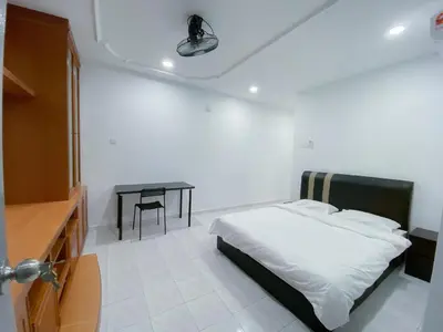 a bedroom with a bed and a table in it at Venice Guest Hostel - Bilik Sahaja in Lumut