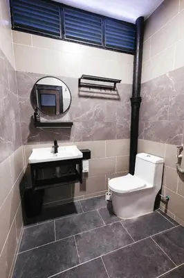 a bathroom with a toilet and a sink and a mirror at monstera homestay near Tambun, Ipoh Garden East in Ipoh