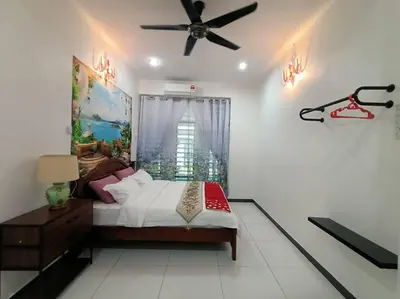 a bedroom with a bed and a ceiling fan at Sweet 3 bedroom home @ Canning Garden, Ipoh in Ipoh