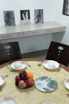 a table with plates of fruit on top of it at Sweet 3 bedroom home @ Canning Garden, Ipoh in Ipoh