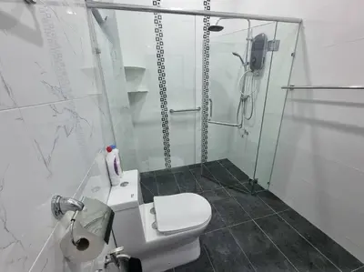 a white bathroom with a shower and a toilet at Sweet 3 bedroom home @ Canning Garden, Ipoh in Ipoh
