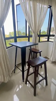 a table and two chairs in front of a window at The Ferringhi Sea View 777 in Batu Ferringhi