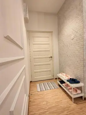 a room with a door and a shelf with shoes at Cameron Lovely Cottage 3 Rooms in Tanah Rata
