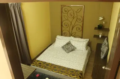 a small bedroom with a bed with pillows at 1 MINUTES TO TOWER SENTRAL INTAN HOMESTAY 6 ROOMS in Teluk Intan