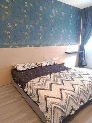 a bedroom with a bed with a blue wall at Muslim Homestay blue Adik Aisyah Apartment in Tanah Rata