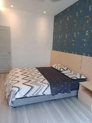 a bedroom with a large bed with a headboard at Muslim Homestay blue Adik Aisyah Apartment in Tanah Rata