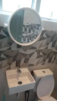 a bathroom with a sink and a mirror and a toilet at Muslim Homestay blue Adik Aisyah Apartment in Tanah Rata