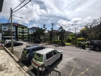 a white car is parked in a parking lot at ZE II Homestay_Cameron in Tanah Rata