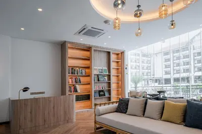 a living room with a couch and a book shelf at Bertam Resort & Water Park Penang in Kepala Batas