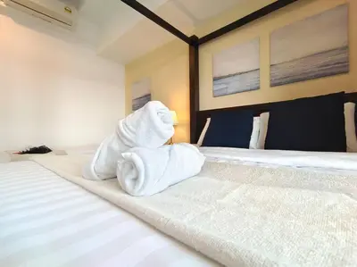 a bedroom with two white towels on a bed at 【NEW】Cozy&Warm Studio@Juru Sentral Icon City in Bukit Mertajam