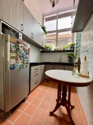 a kitchen with a table and a refrigerator at Pertak Siring at Kuala Kubu Bharu in Kuala Kubu Baharu