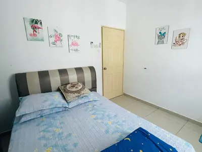 a bedroom with a bed with a pillow on it at NO 121 NAZIRIN HOMESTAY TMN DESA MANJUNG in Lumut