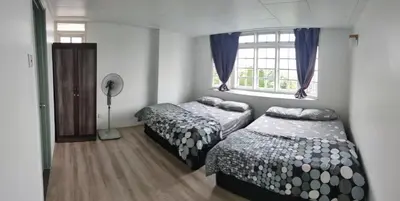 a bedroom with two beds and a window at Fraser Hill Silverpart Resort A3-1-1 Forest View With Lift in Bukit Fraser