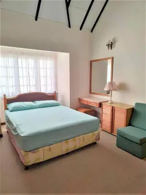 a bedroom with a bed and a chair and a mirror at Fraser Hill Silverpart Resort B2-6-1 Forest View High Floor No Lift in Bukit Fraser