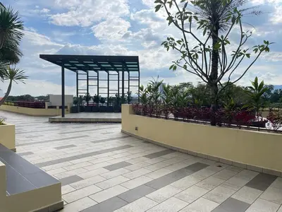 a building with a pavilion with trees and plants at R&C Guesthouse in Ipoh