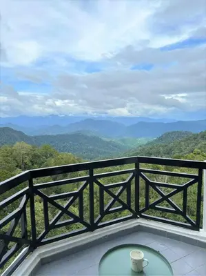 a table on a balcony with a view of mountains at Fraser Hill Silverpart Resort A3-6-3A Best View With Lift in Bukit Fraser