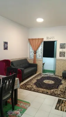 a living room with a couch and a tv at Emily Homestay Cameron Highlands in Tanah Rata